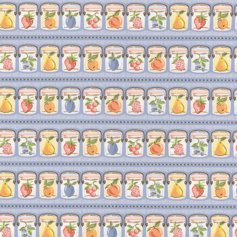 Rows of canning jars holding fresh fruits of the season on azure blue fabric.