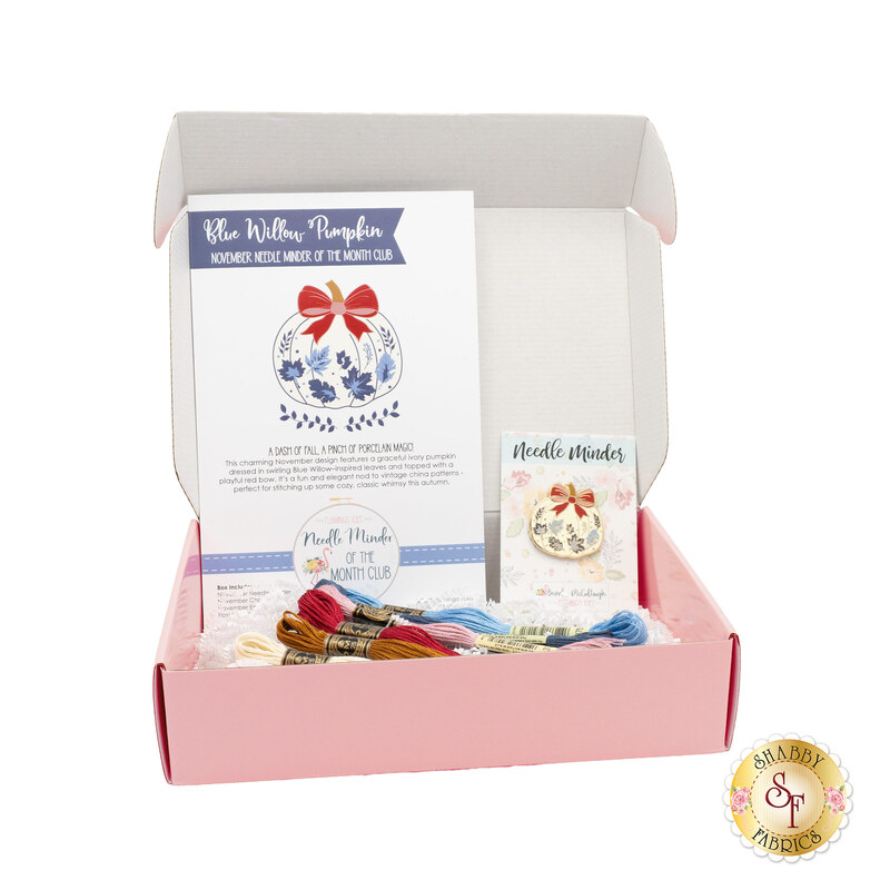 The November Needle Minder of the Month box, open and showing the contents, from the pattern to the floss and needle minder.