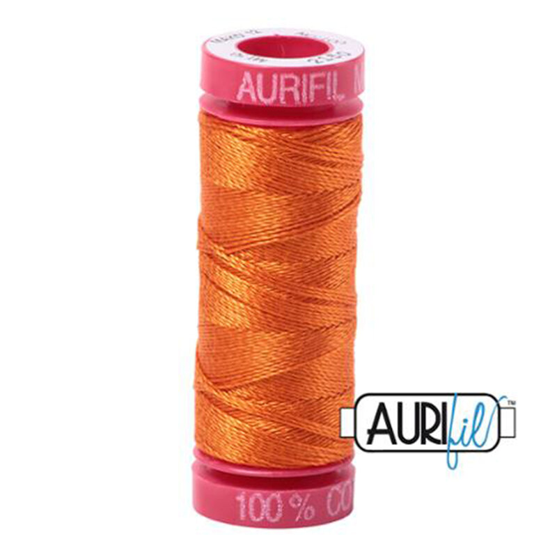 Pumpkin thread on a red spool, isolated on a white background