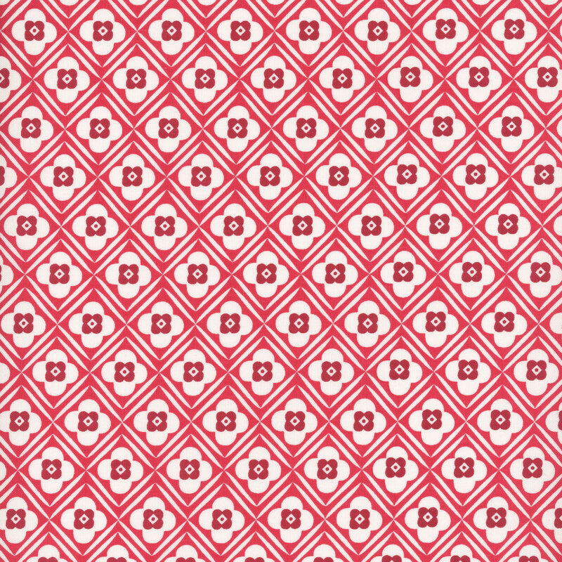 Red diagonal lattice and floral design on white fabric.