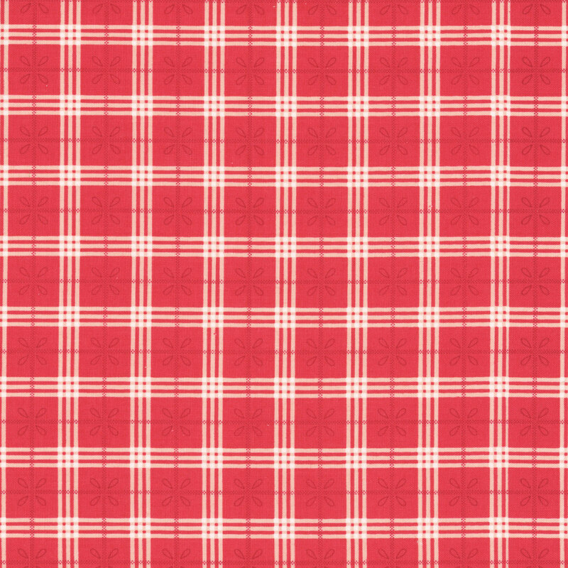 Red and white plaid and floral design on white fabric.
