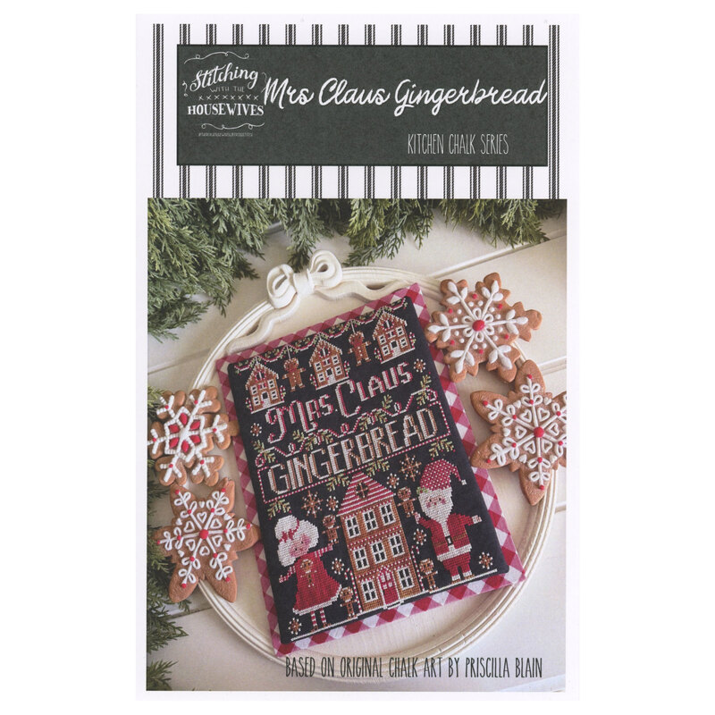 The front of the Mrs. Claus Gingerbread cross stitch pattern showing the completed project featuring gingerbread babies and houses surrounded by coordinating holiday décor. 