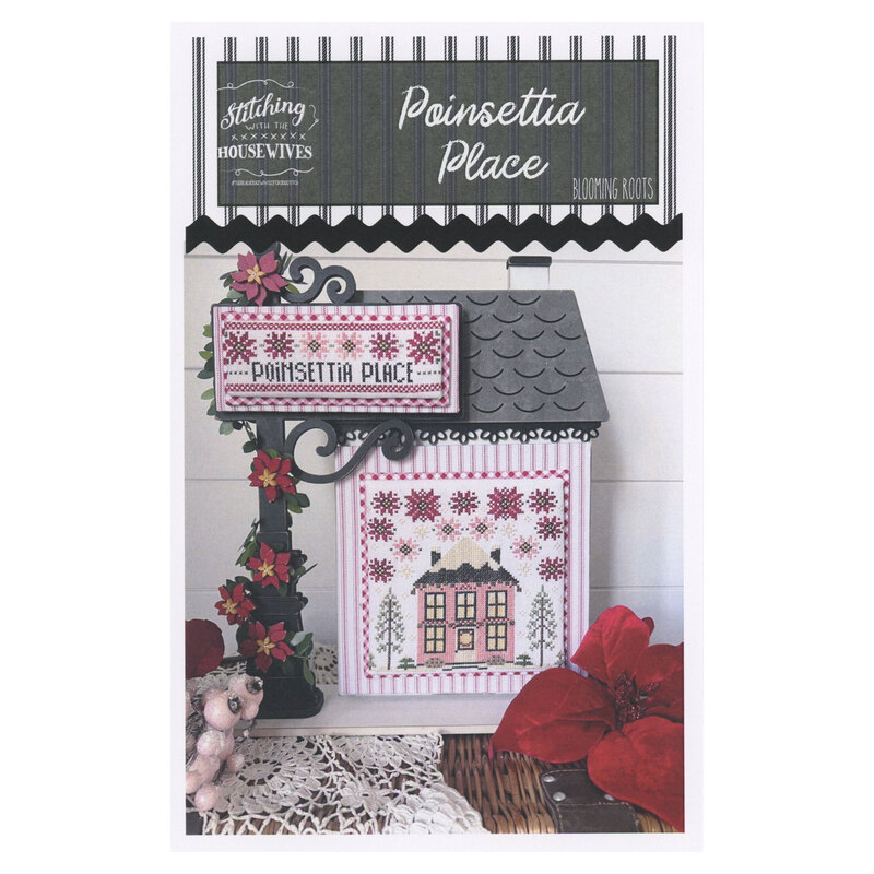 The front of the Blooming Roots Poinsettia Place cross stitch pattern showing the completed project featuring a pink house and poinsettias surrounded by coordinating holiday décor. 