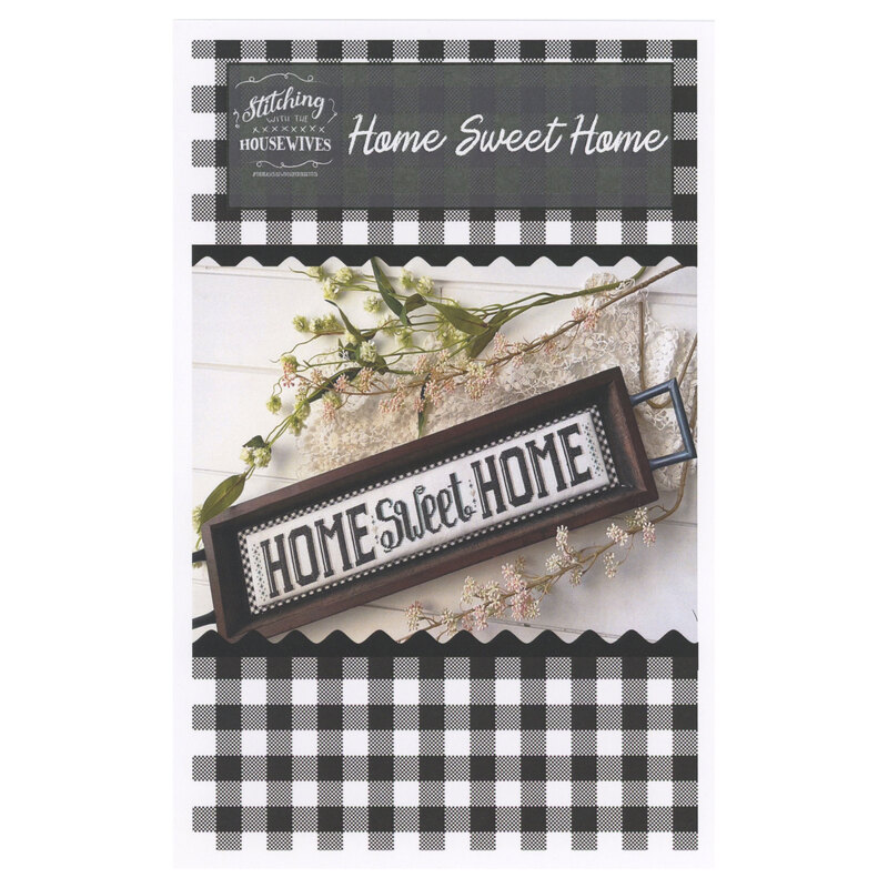 The front of the Home Sweet Home cross stitch pattern showing the completed project surrounded by coordinating home décor. 