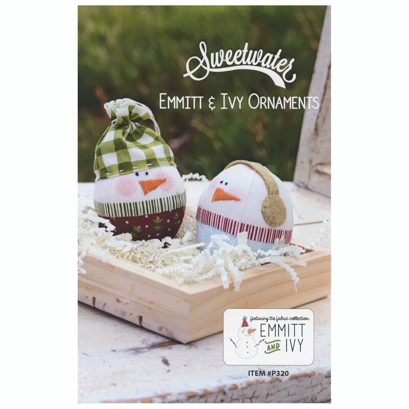 The front of the Emmitt & Ivy Ornaments pattern on a wooden chair background with white paper as snow.