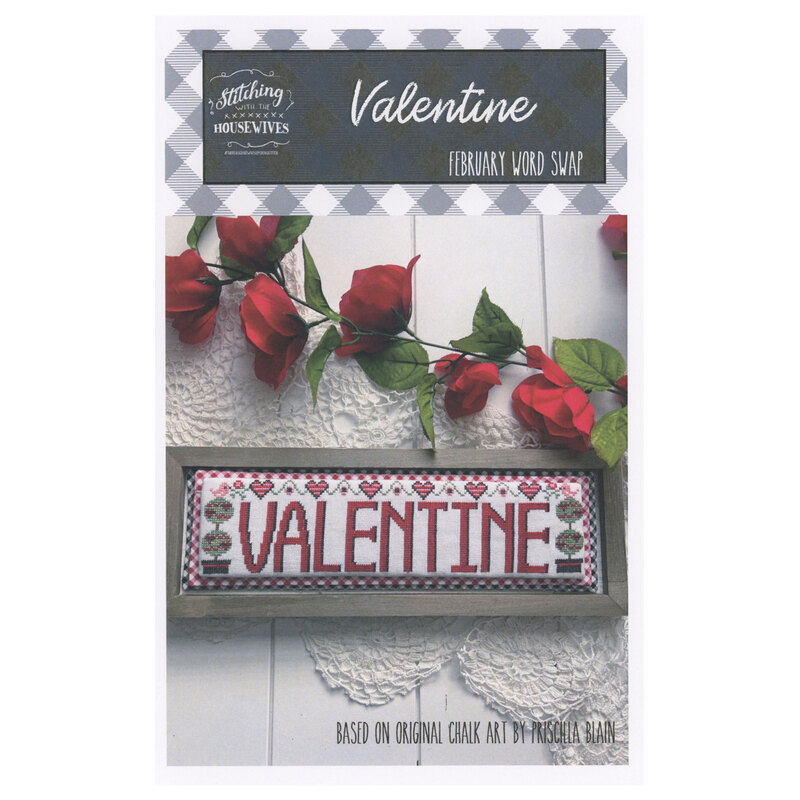The front of the Valentine Word Swap cross stitch pattern showing the completed project surrounded by coordinating holiday décor. 