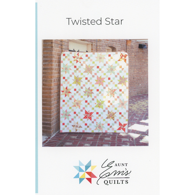 Cover of Twisted Star quilt pattern featuring a colorful quilt design against a brick wall.