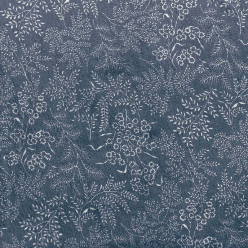 Navy blue fabric featuring a stamped, white floral and leaves design.