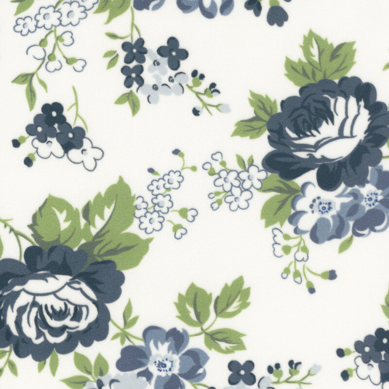 white fabric featuring large navy blue flowers and grass green leaves.