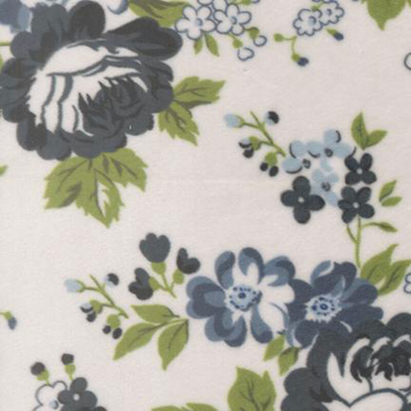 Cream fabric featuring large navy blue flowers and grass green leaves.