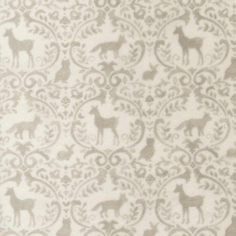 Cream fabric with a tan ornamental pattern adorned with woodland animals and forest motifs.