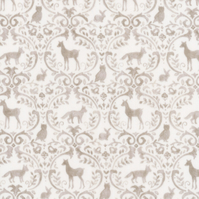 White fabric with a tan ornamental pattern adorned with woodland animals and forest motifs.