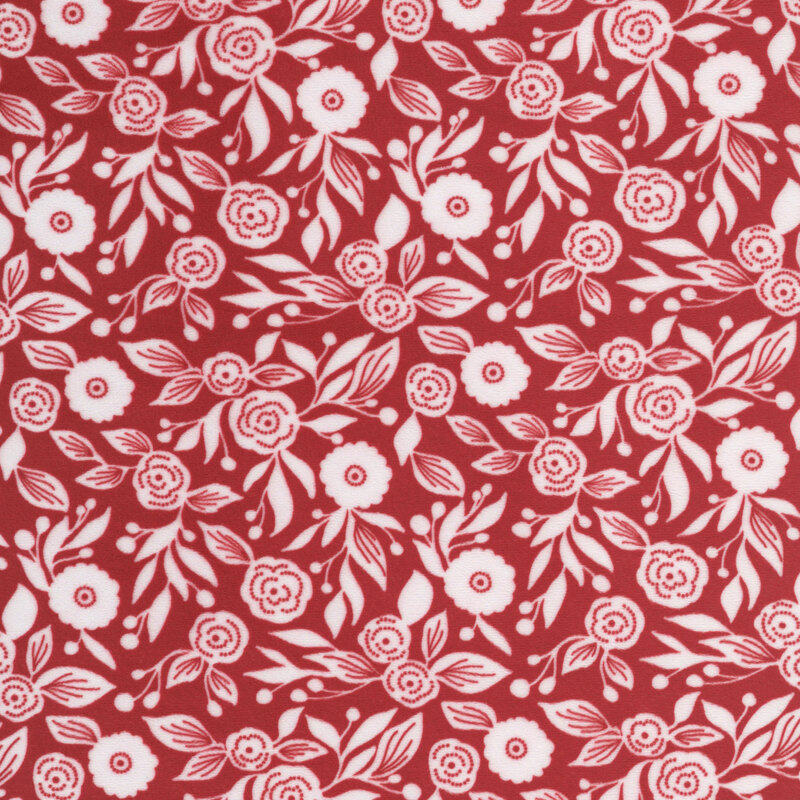 Red minky fabric with a two-dimensional design of white stylized florals and leaves.