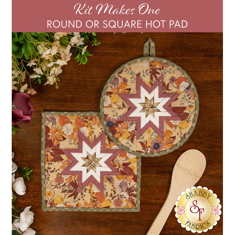 The two completed butter colored Folded Star Hot Pads, one round and one square, slightly overlapping each other and staged on a wooden table with coordinating décor.