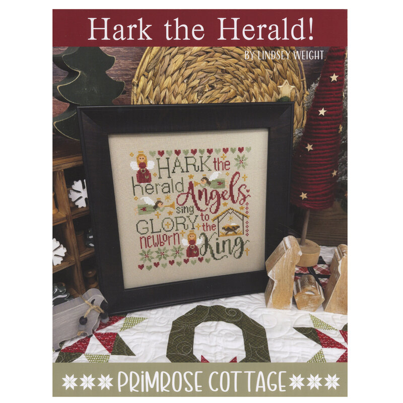 Front of the Hark the Herald! pattern showing the completed design finished into a pillow and staged with coordinating decor.