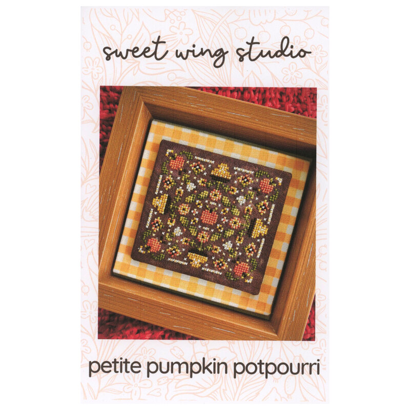 Cross-stitch pattern featuring a radial autumn-themed design, with pumpkins and flowers