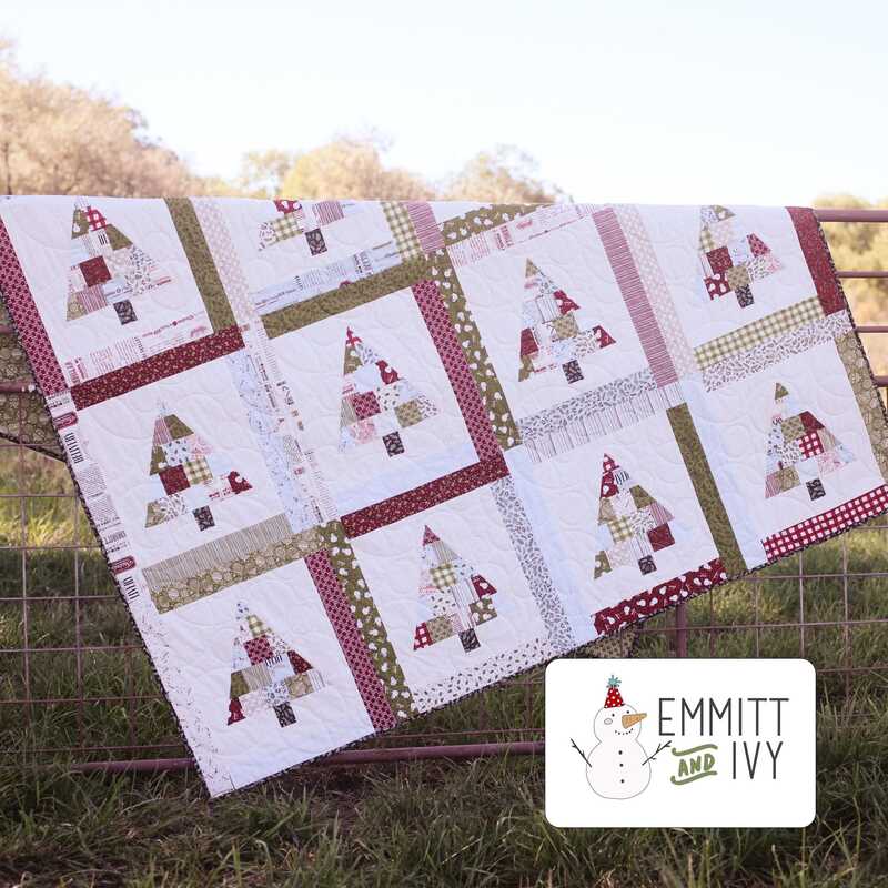 Image of the finished quilt hanging on a fence in a sunlit field and the Emmitt and Ivy Logo