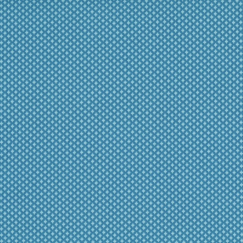 A denim blue fabric with a pattern of tiny, tonal blue diamonds