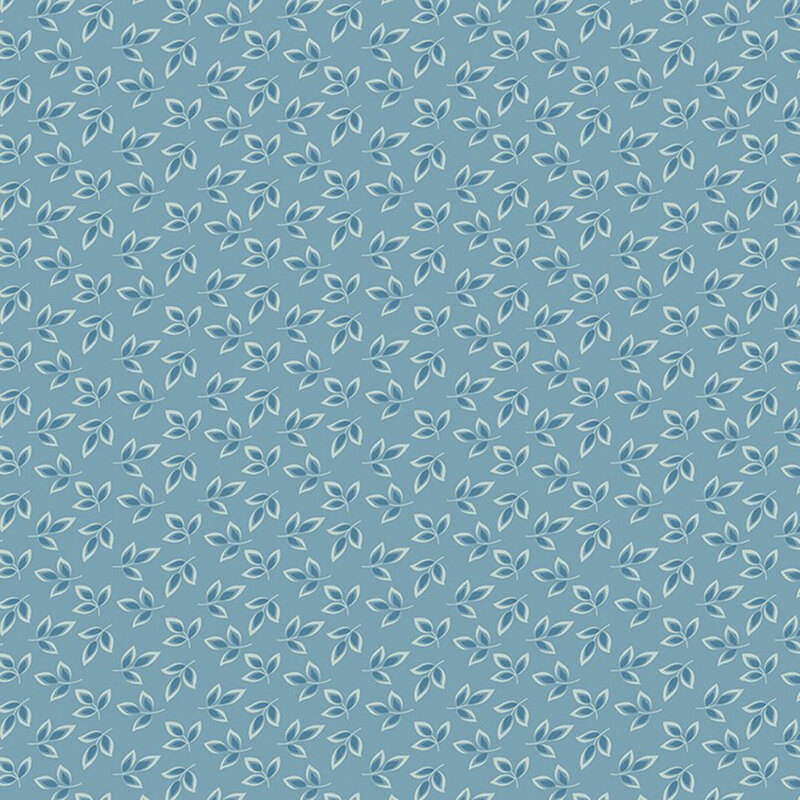 Denim blue fabric with a dense pattern of light blue and navy leaves 