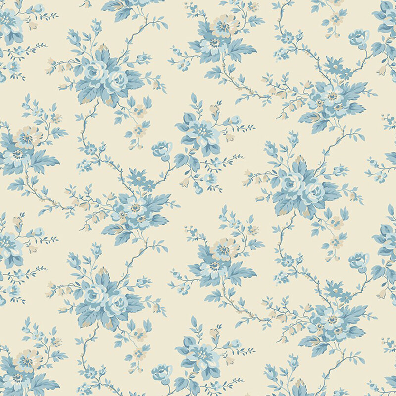 A toile pattern of blue florals and stems on a cream fabric 