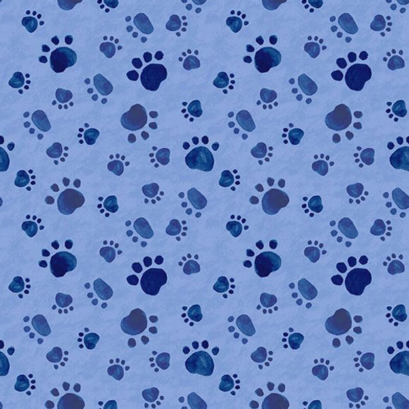 mottled blue fabric with a tossed pattern of paw prints in navy.