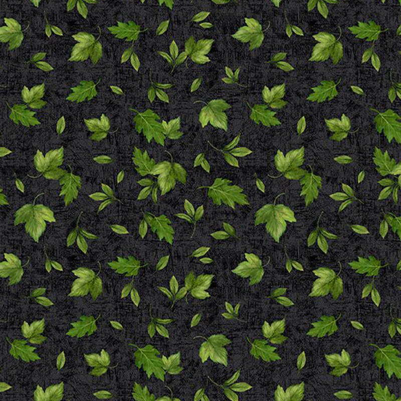 Black fabric with a tossed assortment of green summer leaves on a mottled background. 