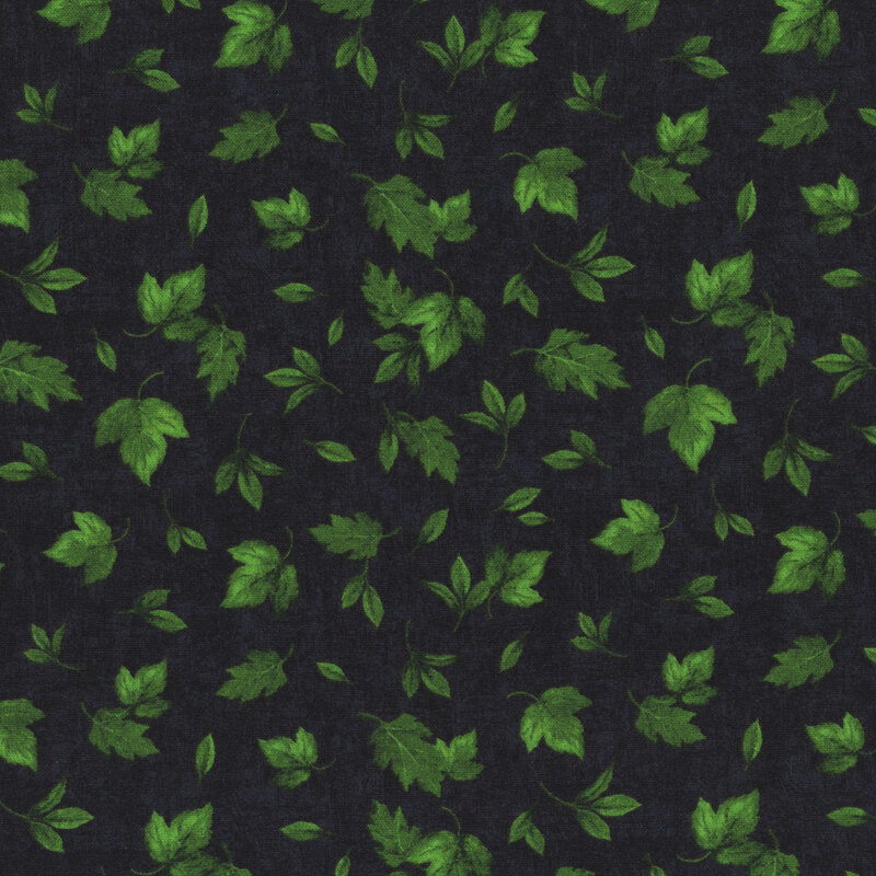 Black fabric with a tossed assortment of green summer leaves on a mottled background. 