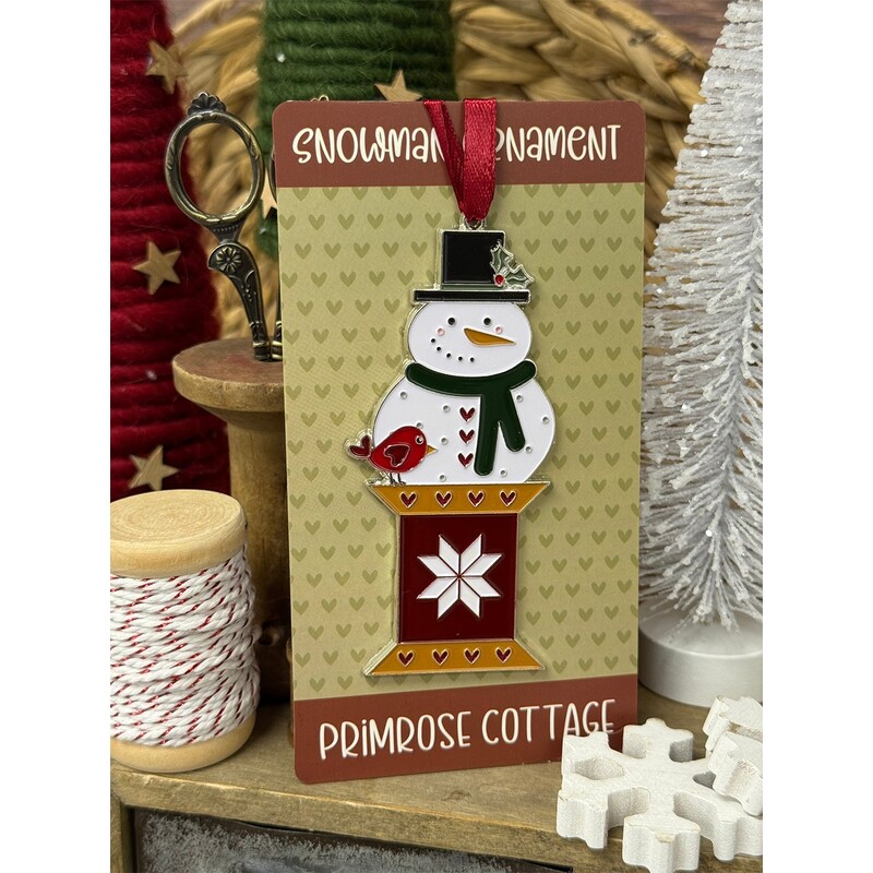 A festive snowman ornament on a decorative card, labeled Snowman Ornament Primrose Cottage.