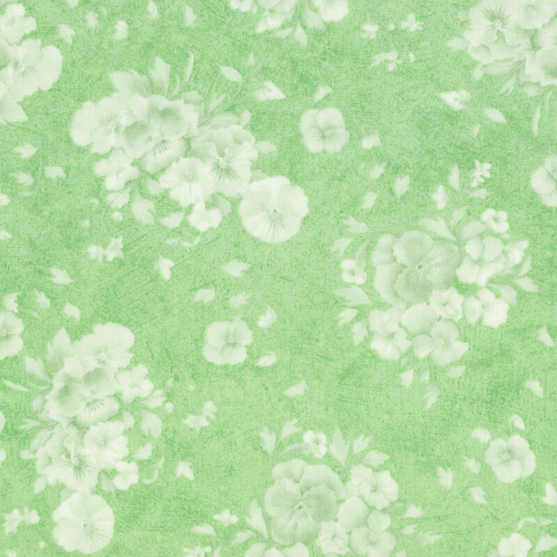 textured spring green fabric with a subtle pattern of white florals and leaves.