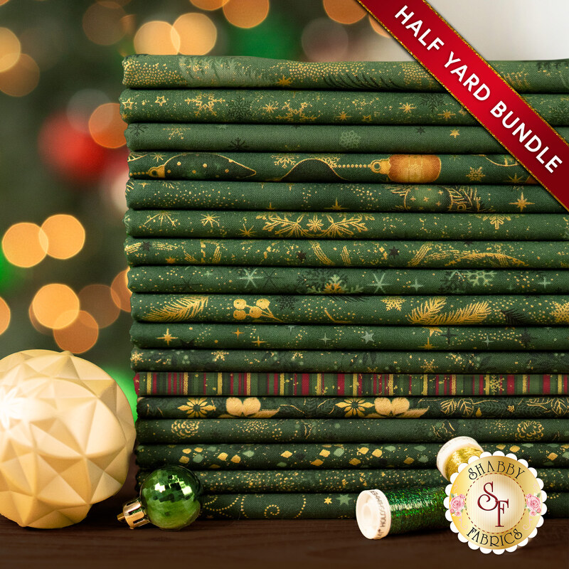 A stack of the seventeen fabrics included in the 17 HY Bundle Green/Gold by Stof Fabrics, staged with ornaments and thread.