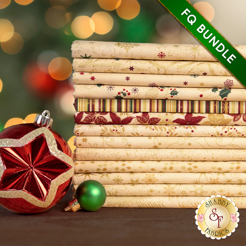 A stack of the thirteen fabrics included in the 13 FQ Bundle Tan/Gold by Stof Fabrics, staged with ornaments.