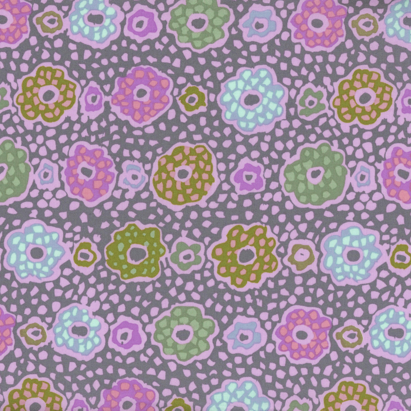 Purple fabric featuring multicolored flowers with lavender outlines and abstract shapes in the background.