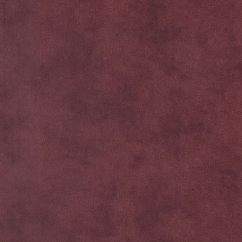Mottled linen textured fabric in deep wine red