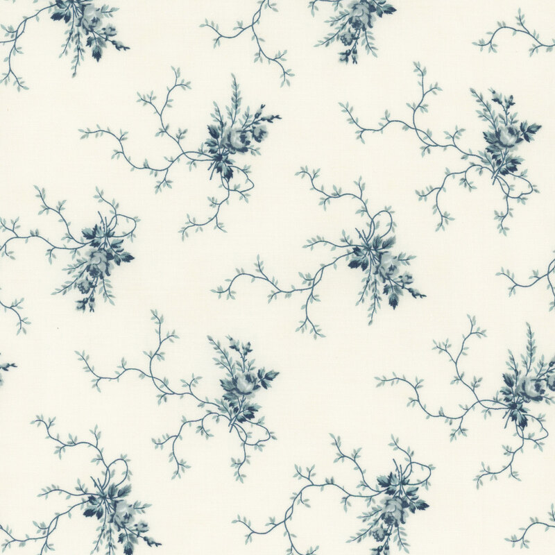 A cream fabric with clusters of blue floral motifs and creeping vines. 