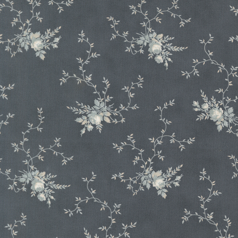 A muted dark blue fabric with clusters of light blue floral motifs and creeping vines. 