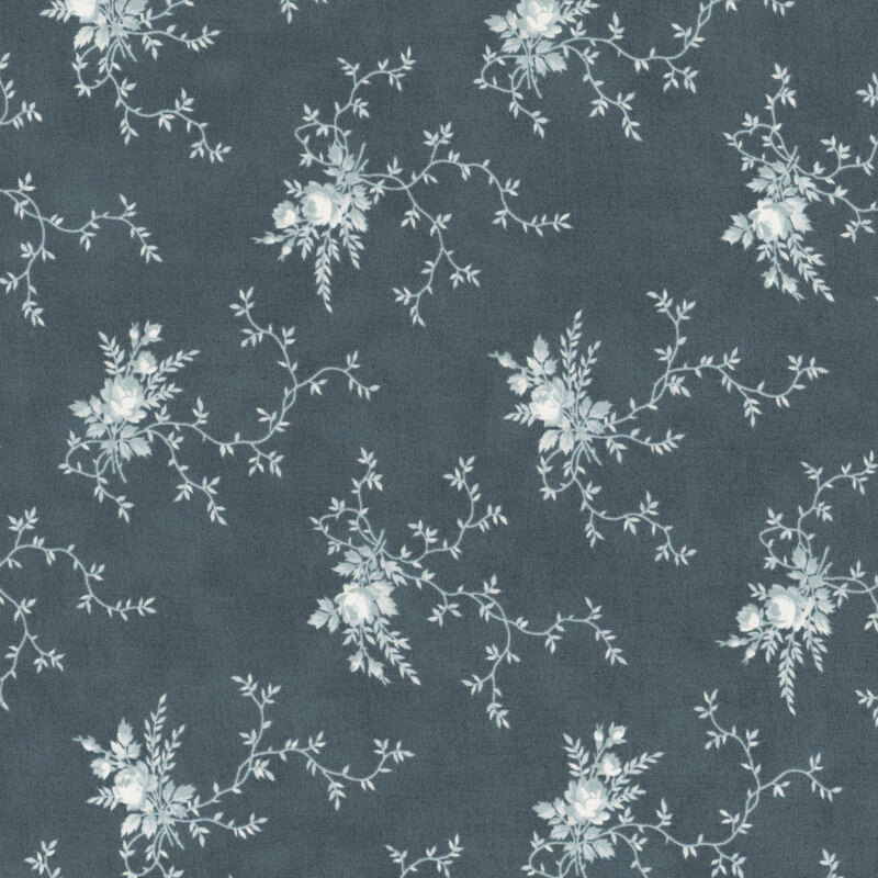 A muted dark blue fabric with clusters of light blue floral motifs and creeping vines. 