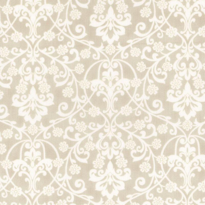 A cream damask fabric with white scrolling florals, vines, leaves, and ornamental motifs. 