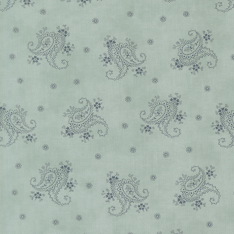 A light blue fabric with tossed blue modified paisleys and dotted flowers.