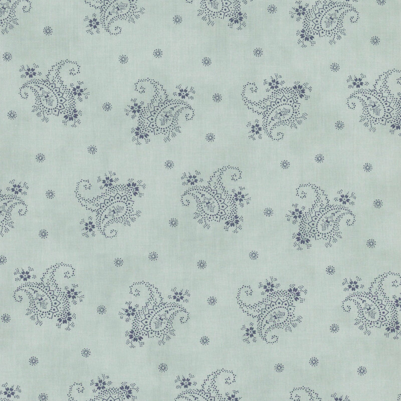 A light blue fabric with tossed blue modified paisleys and dotted flowers.