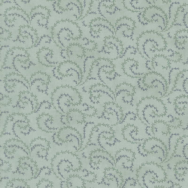 A vintage blue fabric with sea foam green and navy blue organic swirls.