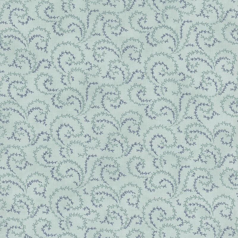 A vintage blue fabric with sea foam green and navy blue organic swirls.