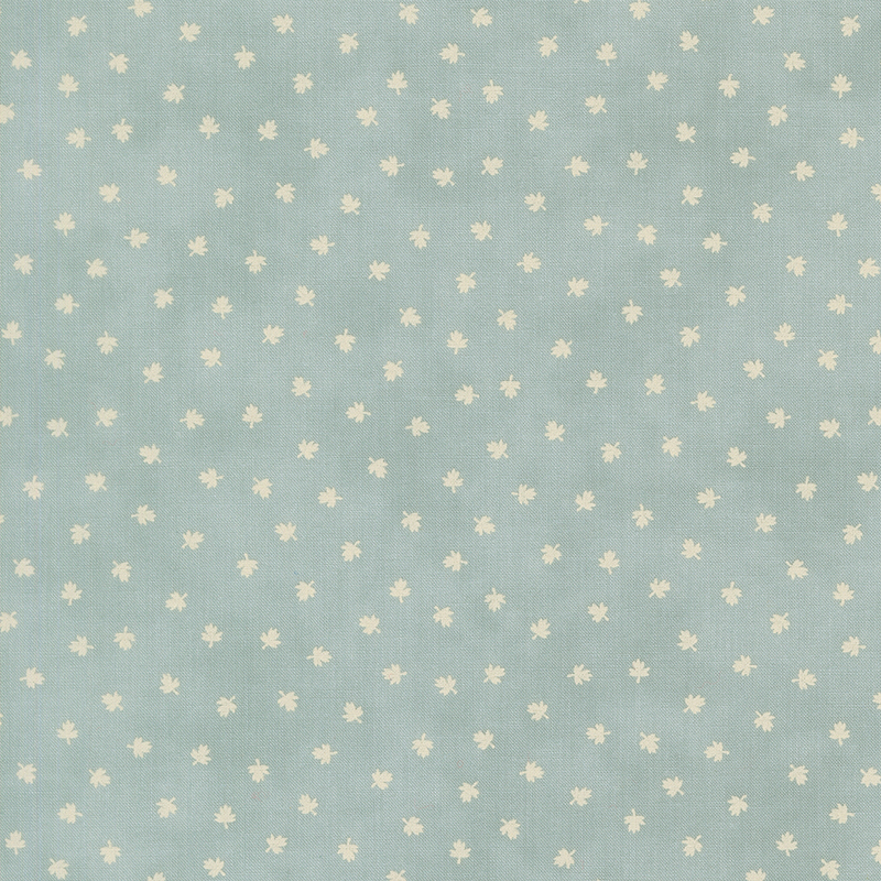 A light blue fabric with scattered cream maple leaves. 