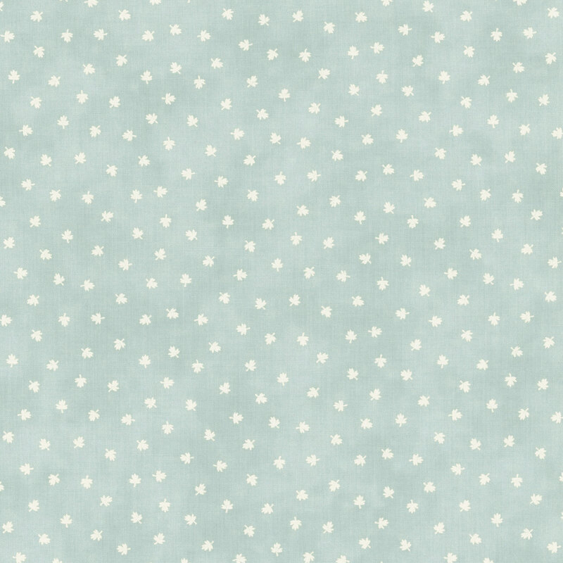 A light blue fabric with scattered cream maple leaves. 
