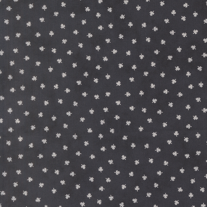 A black fabric with scattered cream maple leaves. 