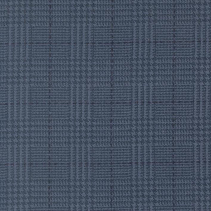 Navy fabric with a tonal blue plaid pattern 