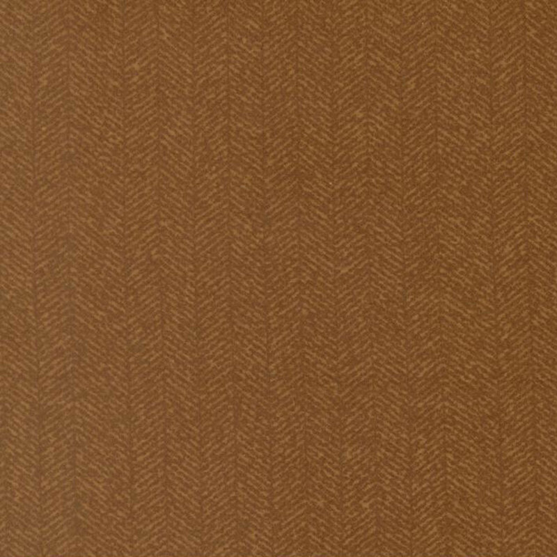 Mustard brown fabric with a dense chevron pattern and tonal flecks