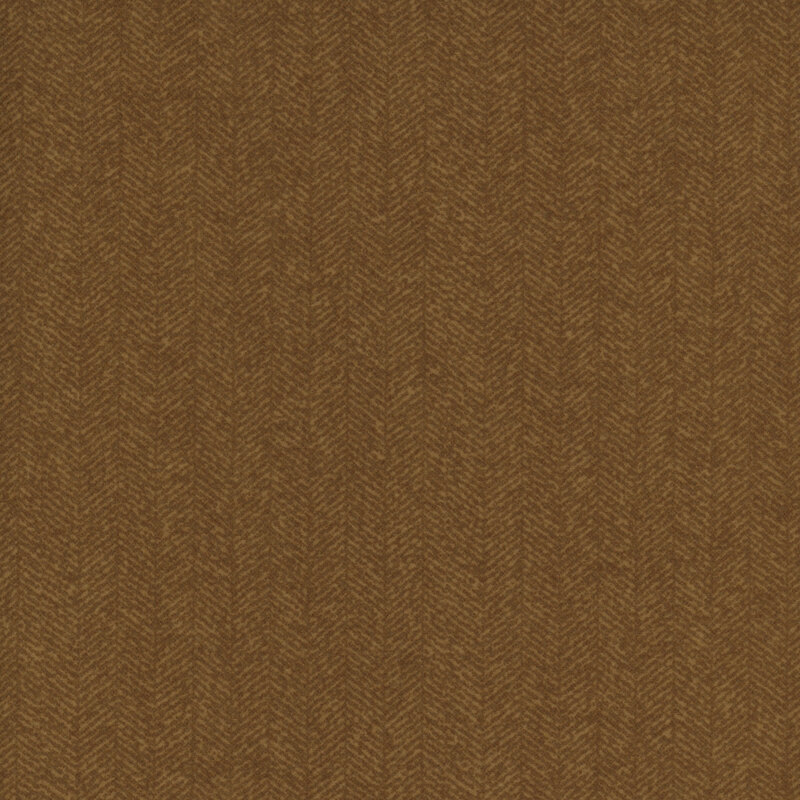 Mustard brown fabric with a dense chevron pattern and tonal flecks