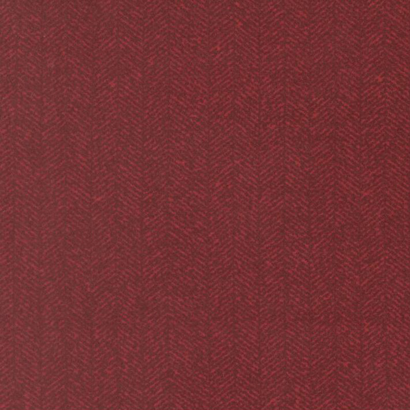 Burgundy fabric with a dense chevron pattern and tonal flecks