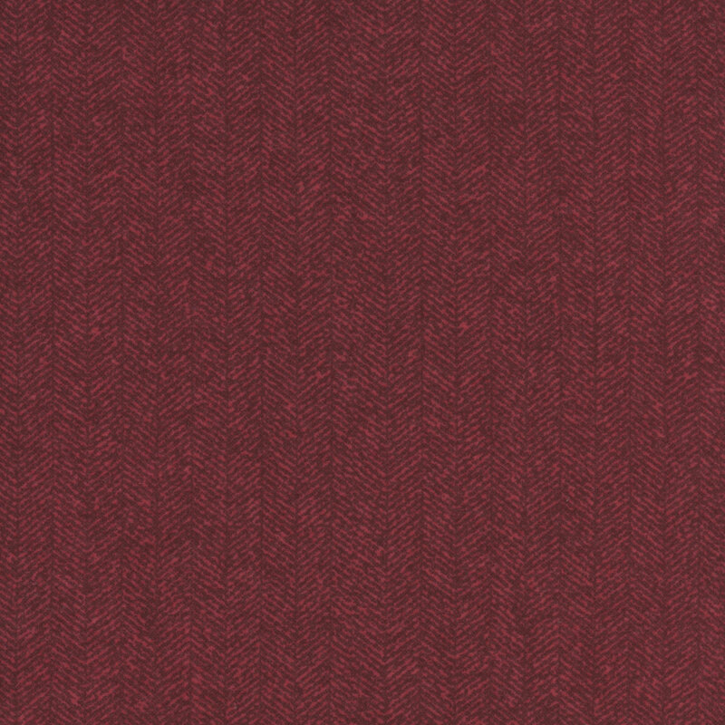 Burgundy fabric with a dense chevron pattern and tonal flecks