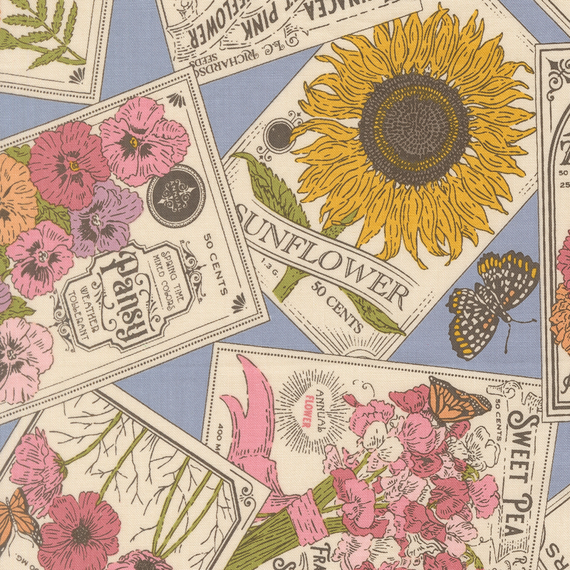 Vintage seed packets of common flowers and butterflies on blue fabric.
